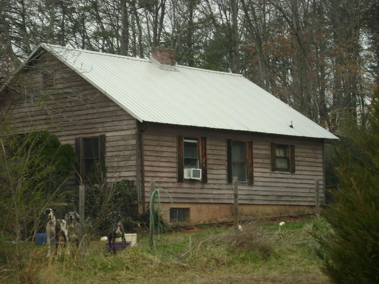 White metal roof on an old wood sided farmhouse, from a Metal Roof Installation job in Fort Atkinson